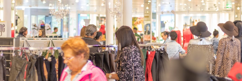 Customer shopping at grand opening event of Courage Mode in Widnau. New outlet for clothing, dresses, shoes and more.